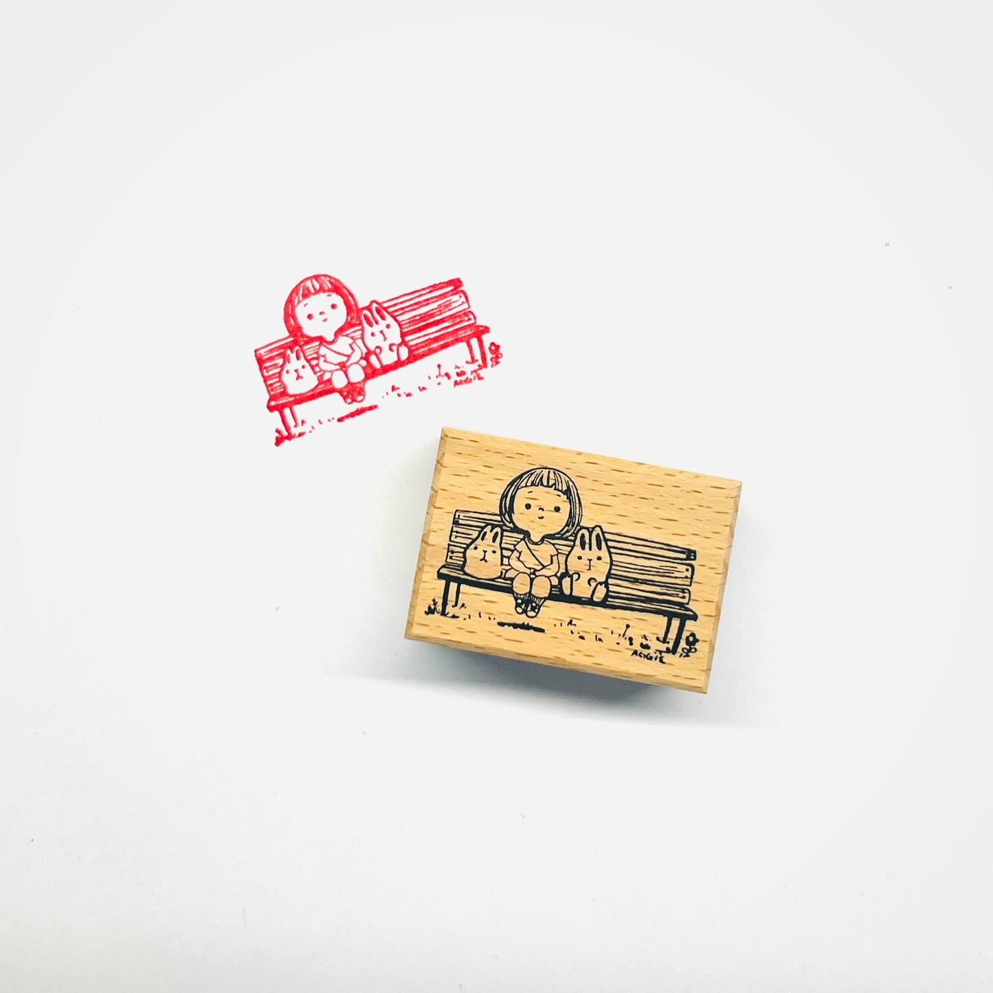 Girl with Bunnies On Bench Stamp